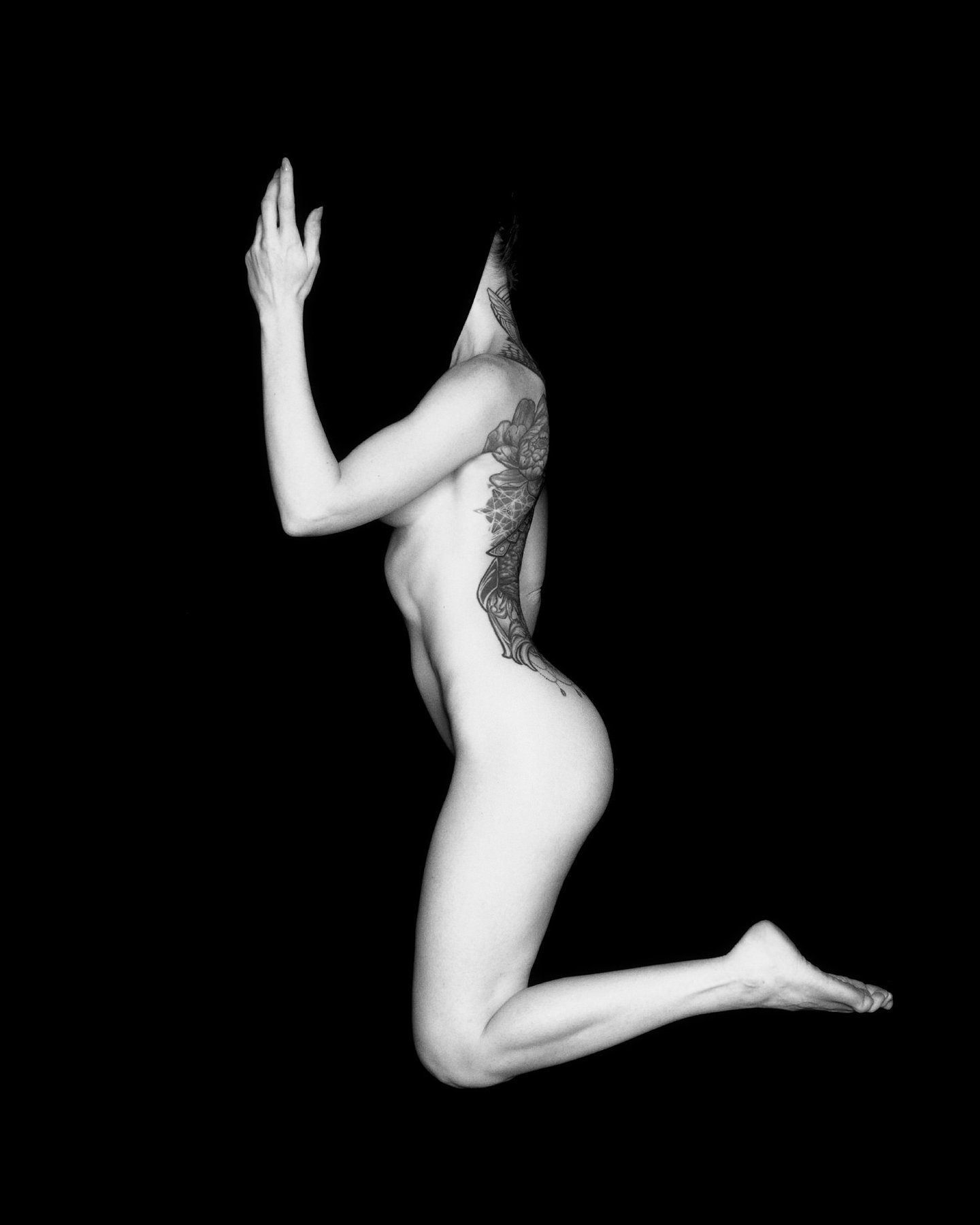 Drift — kneeling figure study lit against pure black, Void series, fine art photography print by Kofi Amoa