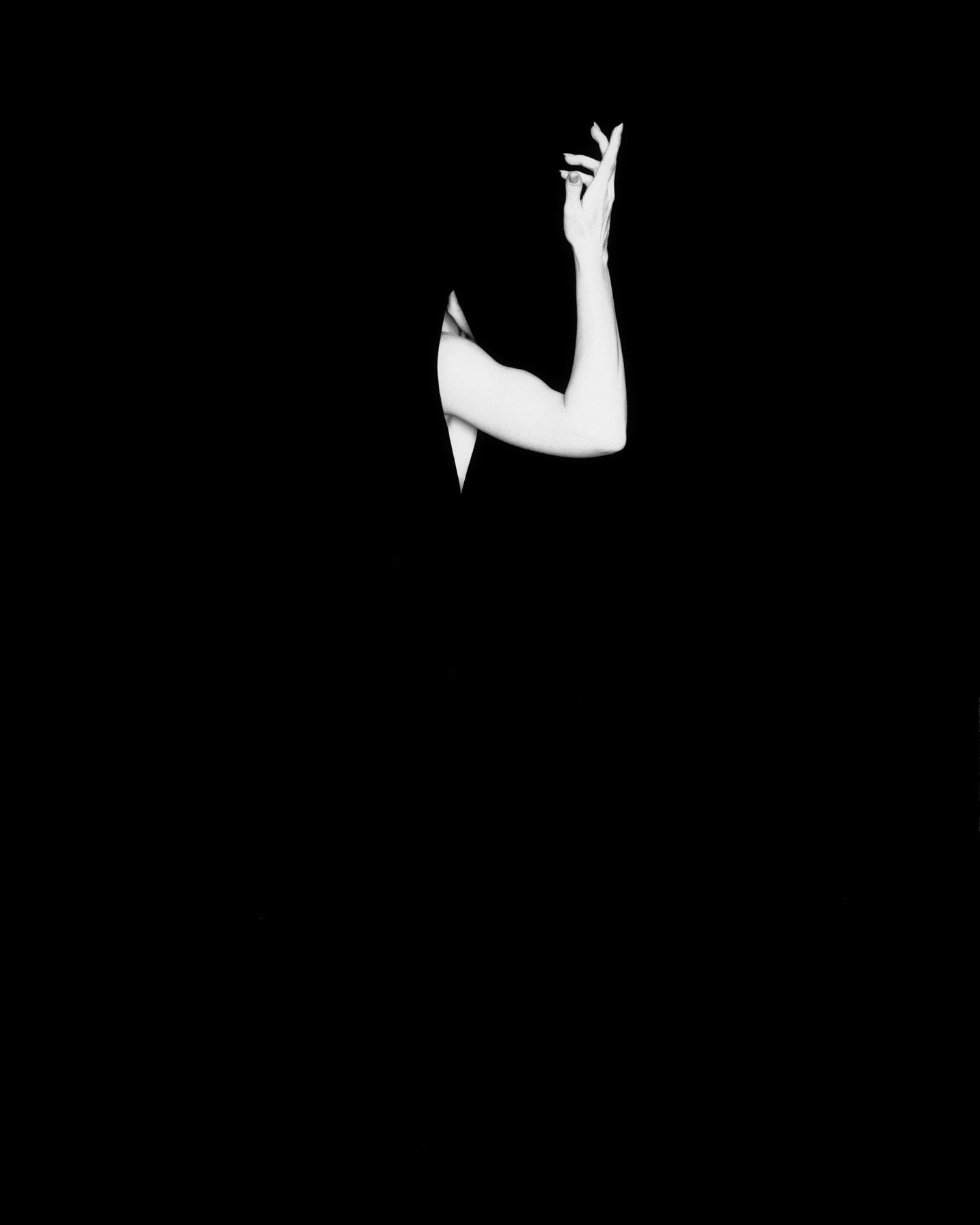 Surface — a single raised arm emerging from pure black negative space, Void series, fine art photography print by Kofi Amoa